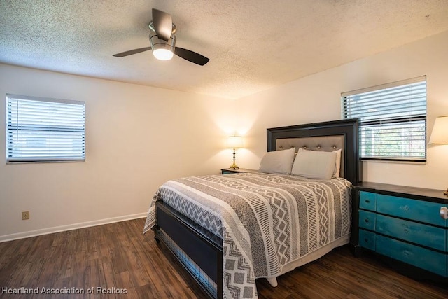 bedroom featuring ceiling fan, dark hardwood / wood-style floors, and a textured ceiling