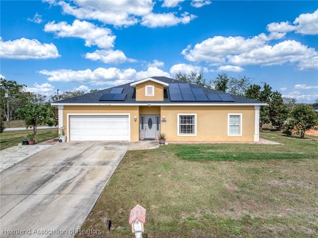 view of front of home with a garage, a front lawn, and solar panels