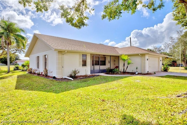 ranch-style house featuring a front lawn and a garage