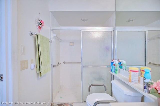 bathroom with toilet and walk in shower