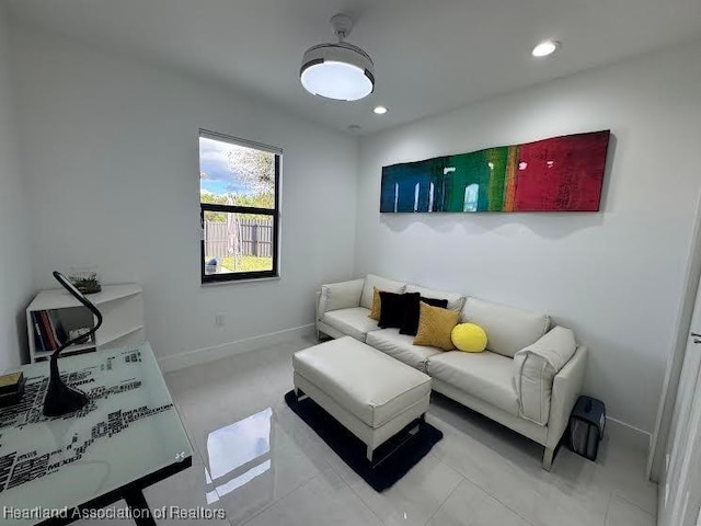 living room with recessed lighting and baseboards