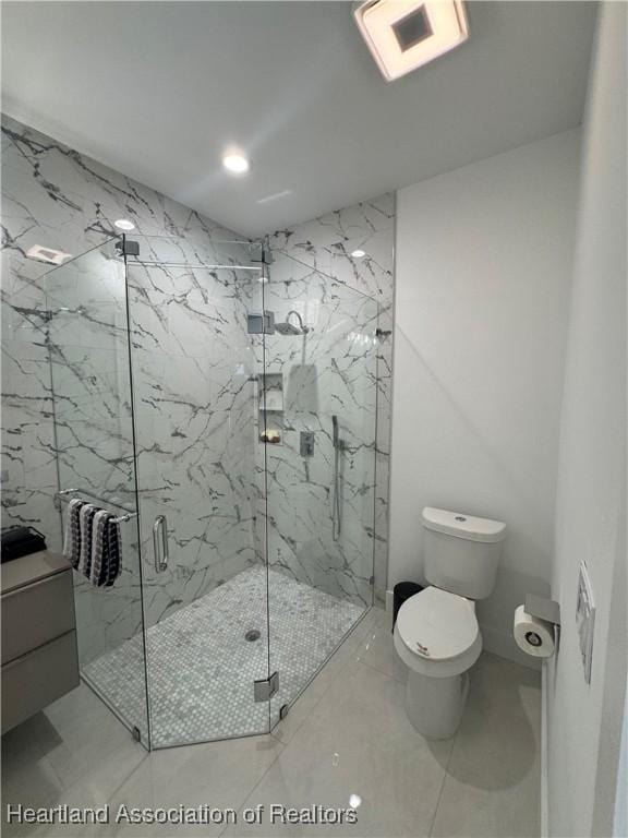 bathroom with toilet, visible vents, and a marble finish shower