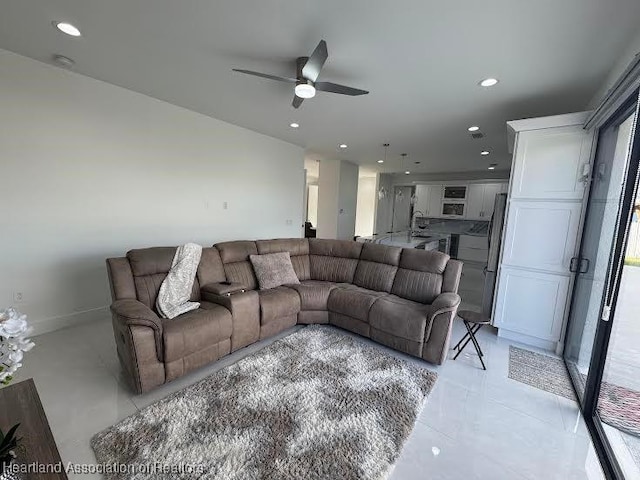 living room with recessed lighting, baseboards, and ceiling fan