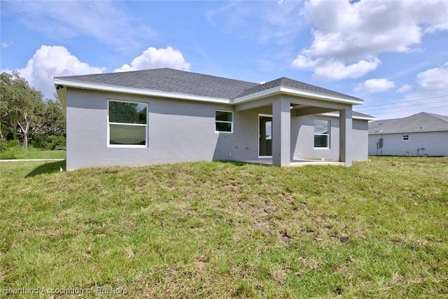 2731 W Albatross Rd, Avon Park, FL 33825 - rear view of property with stucco siding and a lawn