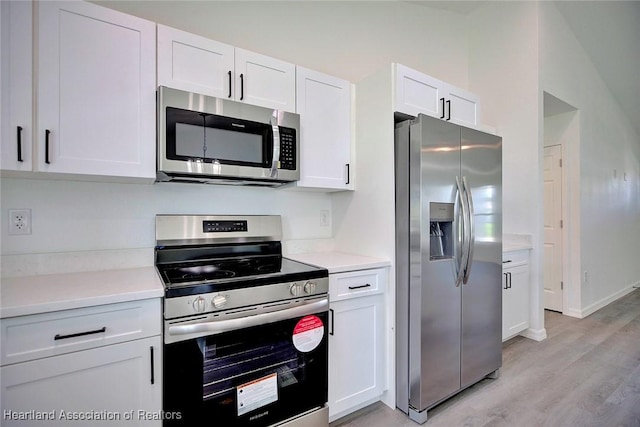 2731 W Albatross Rd, Avon Park, FL 33825 - kitchen with stainless steel appliances, light wood-type flooring, white cabinets, and light countertops