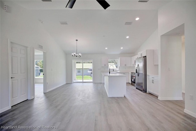 2731 W Albatross Rd, Avon Park, FL 33825 - kitchen featuring stainless steel appliances, light wood finished floors, light countertops, high vaulted ceiling, and recessed lighting