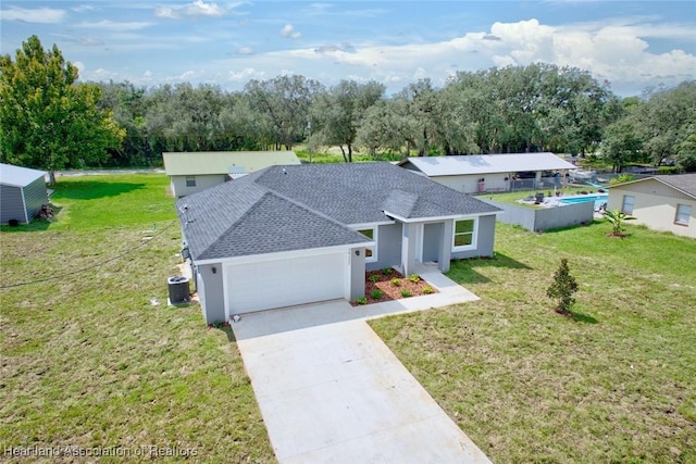 2731 W Albatross Rd, Avon Park, FL 33825 - view of front of property featuring roof with shingles, an attached garage, concrete driveway, a front lawn, and stucco siding