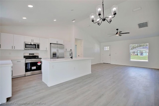 2731 W Albatross Rd, Avon Park, FL 33825 - kitchen featuring appliances with stainless steel finishes, light countertops, high vaulted ceiling, white cabinets, and open floor plan