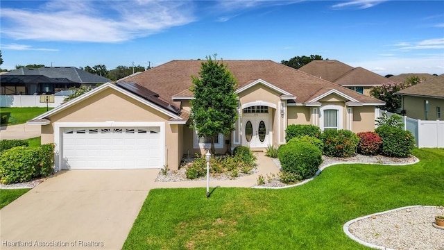302 Ruby Ln, Winter Haven, FL 33884 - view of front facade with stucco siding, an attached garage, and concrete driveway