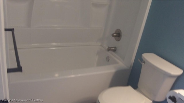 bathroom with toilet and shower / bathing tub combination