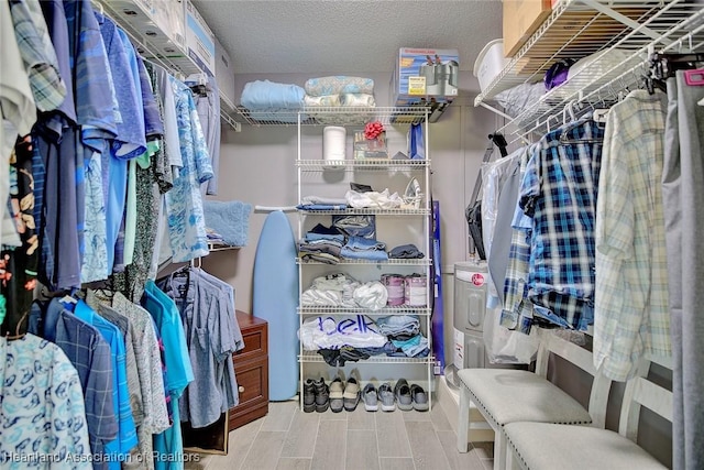 spacious closet with light hardwood / wood-style flooring