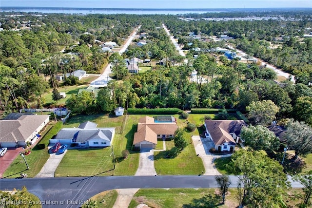 birds eye view of property featuring a residential view and a view of trees