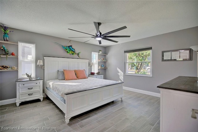 bedroom with a textured ceiling and ceiling fan