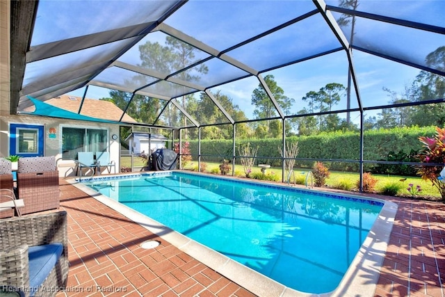 view of swimming pool with a patio and glass enclosure