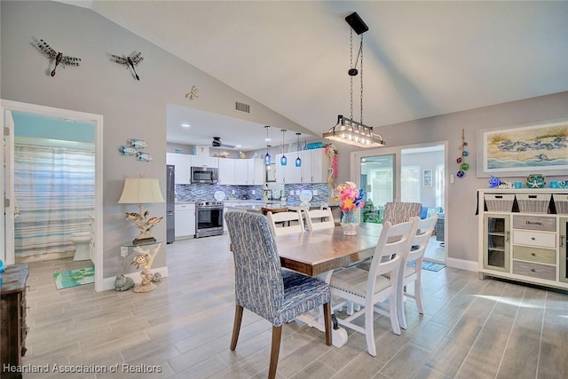 dining space with lofted ceiling