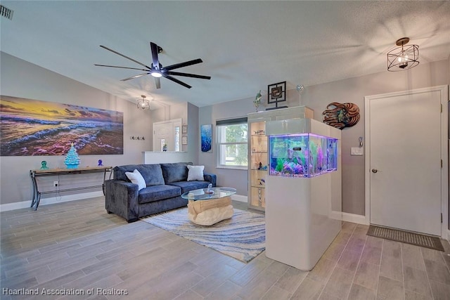 living room featuring light wood-type flooring, vaulted ceiling, and ceiling fan