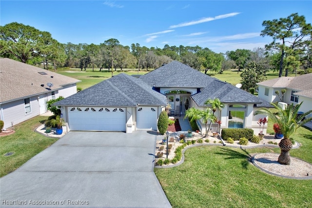 view of front of house featuring a garage, a shingled roof, concrete driveway, and a front yard