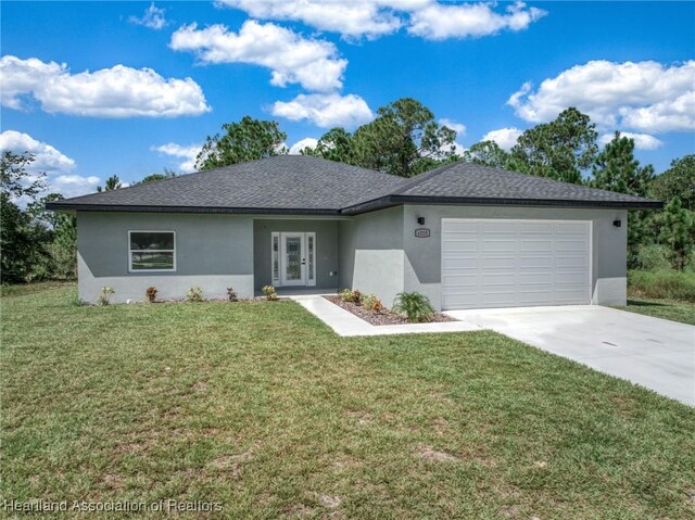 ranch-style home featuring a garage and a front lawn