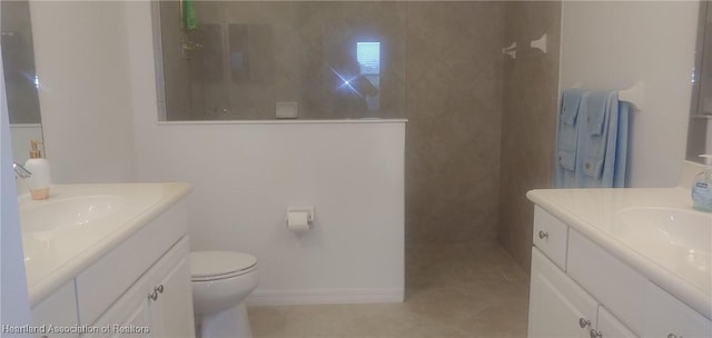 bathroom featuring tile patterned floors, vanity, and walk in shower