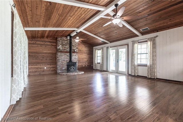 1090 Knollwood Cir, Wauchula, FL 33873 - unfurnished living room with french doors, wooden walls, a wood stove, wood finished floors, and wooden ceiling