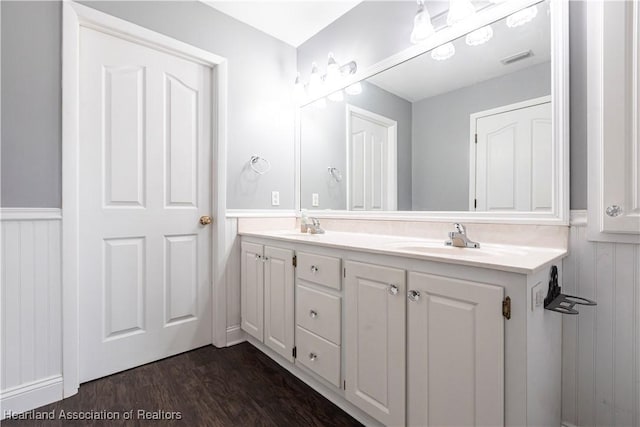 1090 Knollwood Cir, Wauchula, FL 33873 - bathroom with double vanity, wainscoting, and wood finished floors