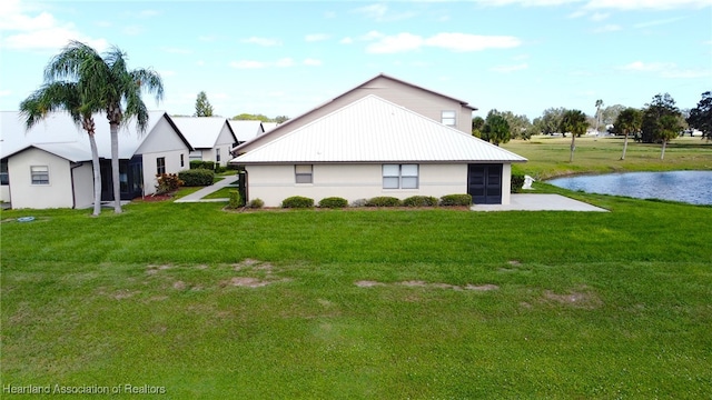 view of side of home featuring a lawn