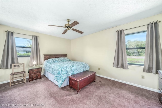 bedroom featuring a textured ceiling, carpet flooring, a ceiling fan, and baseboards