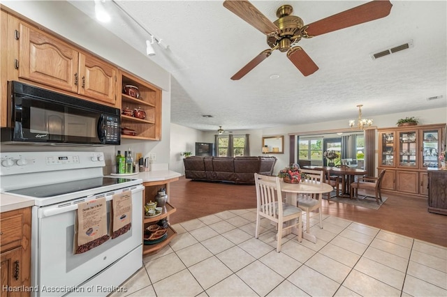 kitchen with visible vents, black microwave, open shelves, and white electric range