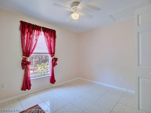 224 Montego Dr, Sebring, FL 33870 - unfurnished room featuring baseboards, a ceiling fan, and attic access