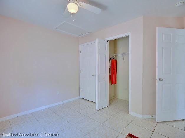 224 Montego Dr, Sebring, FL 33870 - unfurnished bedroom with a closet, baseboards, attic access, and ceiling fan
