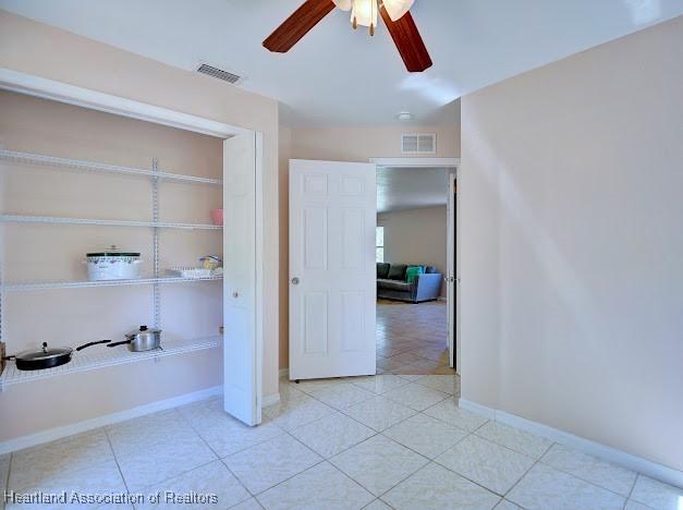 224 Montego Dr, Sebring, FL 33870 - bathroom featuring tile patterned floors, ceiling fan, baseboards, and visible vents