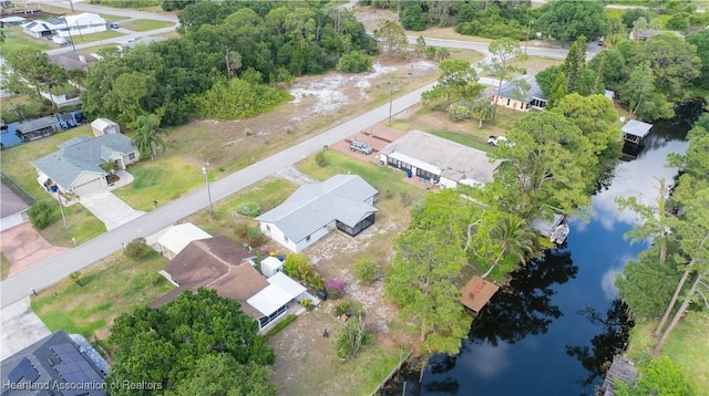 birds eye view of property with a residential view and a water view