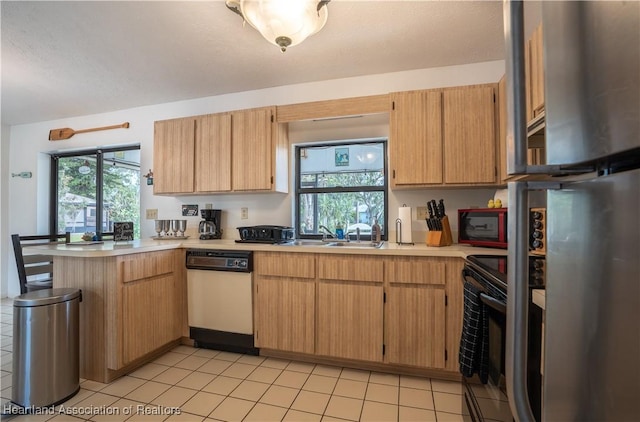 kitchen featuring freestanding refrigerator, a peninsula, light countertops, black range with electric stovetop, and dishwasher