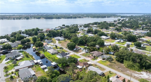 drone / aerial view featuring a residential view and a water view