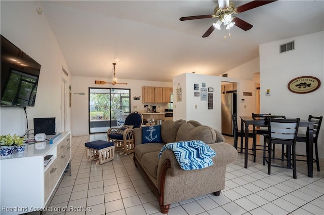 living area with visible vents, a ceiling fan, light tile patterned floors, and lofted ceiling