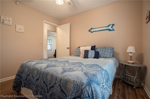 bedroom featuring baseboards and wood finished floors