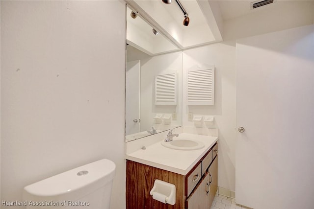 bathroom with vanity and toilet