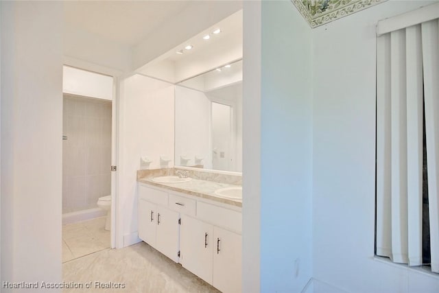 bathroom with tile patterned flooring, vanity, and toilet