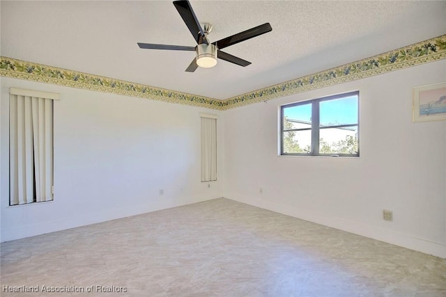 empty room featuring ceiling fan and a textured ceiling