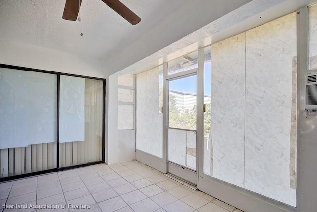 unfurnished sunroom featuring ceiling fan