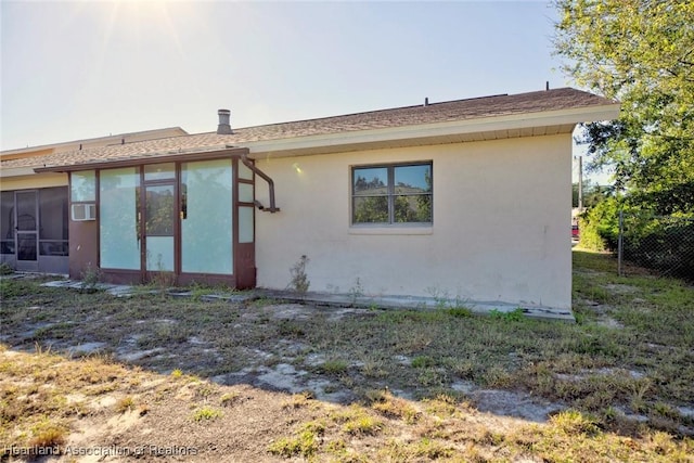 view of home's exterior with a sunroom