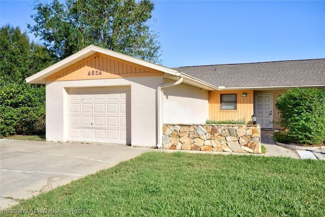 single story home featuring a garage and a front yard