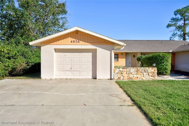 ranch-style home with a garage and a front yard