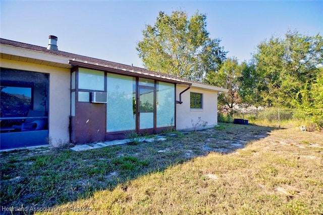 rear view of house featuring a yard