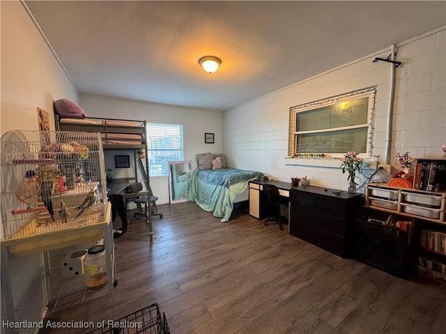 bedroom with dark hardwood / wood-style flooring