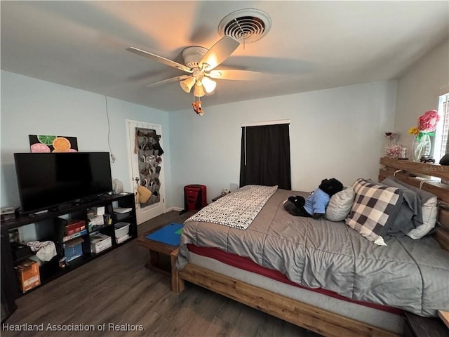 bedroom with dark hardwood / wood-style floors and ceiling fan