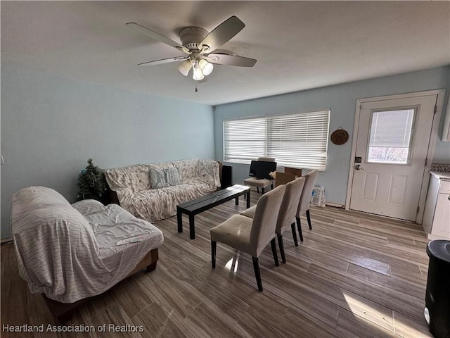 living room featuring ceiling fan and light hardwood / wood-style floors