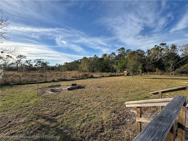 view of yard with a rural view and a fire pit