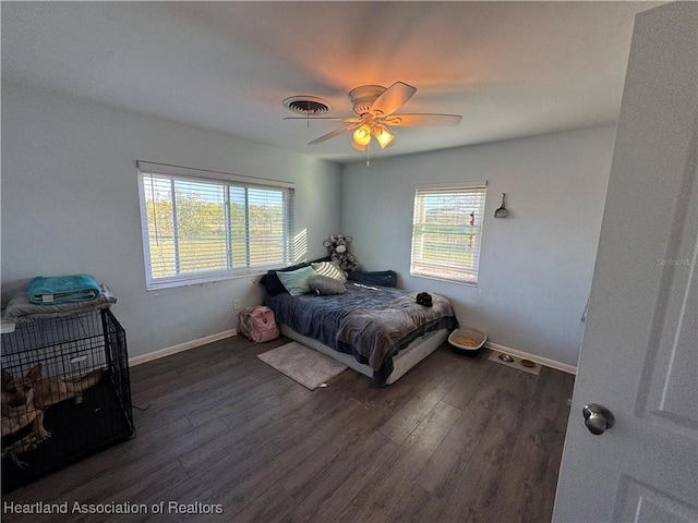 bedroom with dark hardwood / wood-style flooring and ceiling fan