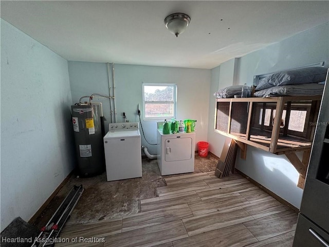 clothes washing area with separate washer and dryer and electric water heater